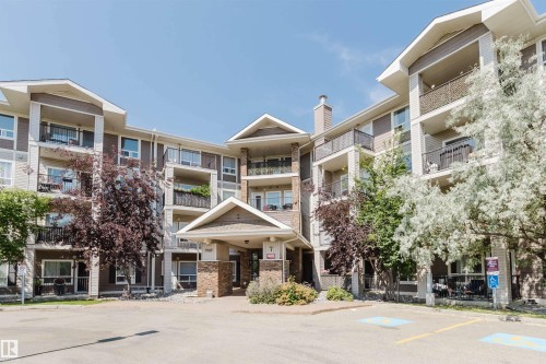 Contemporary apartment building exterior featuring multiple balconies, stone accents, and varied siding - #7306 7327 South Terwillegar Dr Nw, Edmonton, AB - Outdoor With Balcony With Facade