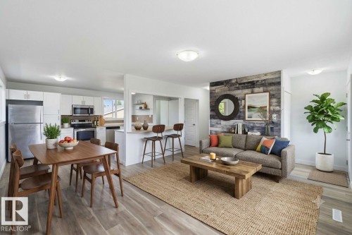 Open-concept living space featuring wood-finish flooring, a kitchen with white cabinetry and stainless steel appliances, and a breakfast bar - 13524 62 Street Nw, Edmonton, AB - Indoor Photo Showing Other Room