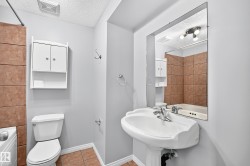 Pedestal sink with chrome faucet, complemented by a large wall-mounted mirror - 