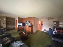 Spacious living area featuring wall paneling and textured wall finishes - 