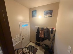 Recessed entry featuring a white panel door with transom-style window - 