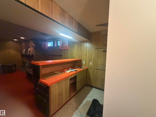 Entertainment space featuring a built-in wet bar with a countertop and sink - 13207 117 Street, Edmonton, AB 