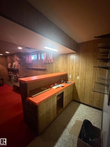 Built-in wet bar with a stainless steel sink and orange countertop - 13207 117 Street, Edmonton, AB 