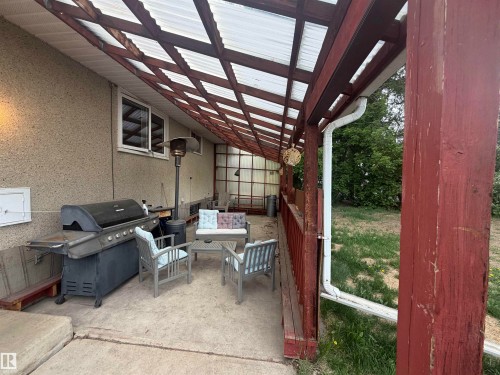 Covered patio featuring a translucent panel roof and concrete flooring - 13207 117 Street, Edmonton, AB 