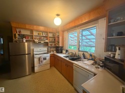 Kitchen featuring wood-finish cabinetry, white countertops, and a white tile backsplash - 