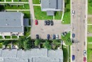 Aerial perspective showcasing multiple residential buildings with gray shingle roofing - #29 13580 38 St Nw, Edmonton, AB  -  