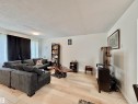 Bright living area featuring wood-finish flooring and white walls - #29 13580 38 St Nw, Edmonton, AB  - Indoor Photo Showing Living Room 