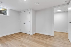 Finished room featuring wood-finish flooring, recessed lighting, and a window well - 