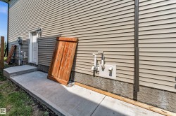 Exterior wall featuring light-colored horizontal siding and a concrete foundation - 