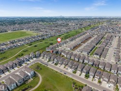 Aerial perspective of a residential neighborhood featuring numerous detached and attached homes - 
