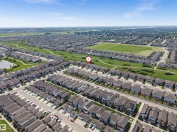Aerial perspective showcasing a residential development with numerous single-family homes - 