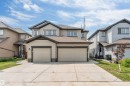 Two-story residence featuring light-colored siding with dark trim accents - 1714 27 St. Nw, Edmonton, AB  - Outdoor With Facade 