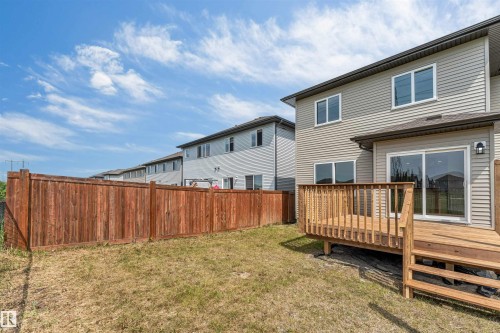 Rear exterior with light-colored siding and a wooden deck - 1714 27 St. Nw, Edmonton, AB - Outdoor