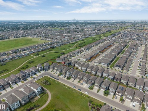 Expansive aerial perspective showcasing a residential development with multiple detached homes featuring varied architectural styles and rooflines - 1714 27 St. Nw, Edmonton, AB - Outdoor With View