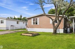 Brown horizontal siding with white trim and shutters - 