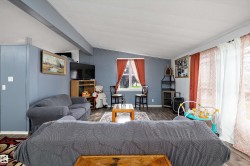 Spacious living area featuring plank flooring and a neutral ceiling - 