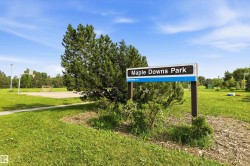 Maple Downs Park sign with surrounding green space - 
