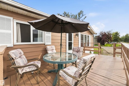 Expansive outdoor deck featuring wood-finish flooring, a wood railing, and a tan siding exterior - 46 Maple Terrace Northwest, Edmonton, AB - Outdoor With Deck Patio Veranda With Exterior