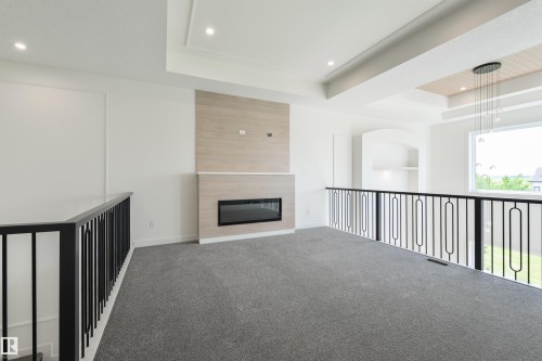 23 Lakevista, Beaumont, AB - Indoor Photo Showing Other Room With Fireplace
