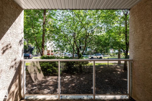 Balcony with glass panel railing and textured exterior walls - #103 12838 65 St Nw Nw, Edmonton, AB - Outdoor