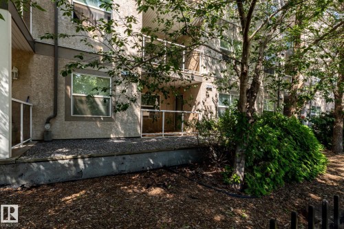 Ground-level patio with glass panel railing - #103 12838 65 St Nw Nw, Edmonton, AB - Outdoor