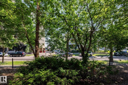 Lush green foliage and mature trees provide natural screening - #103 12838 65 St Nw Nw, Edmonton, AB - Outdoor