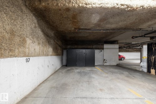 Designated parking space with concrete flooring and marked parking lines - #103 12838 65 St Nw Nw, Edmonton, AB - Indoor Photo Showing Garage