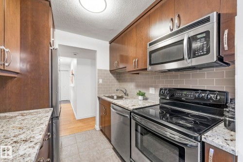 #105 11011 86 Av Nw, Edmonton, AB - Indoor Photo Showing Kitchen With Stainless Steel Kitchen With Upgraded Kitchen