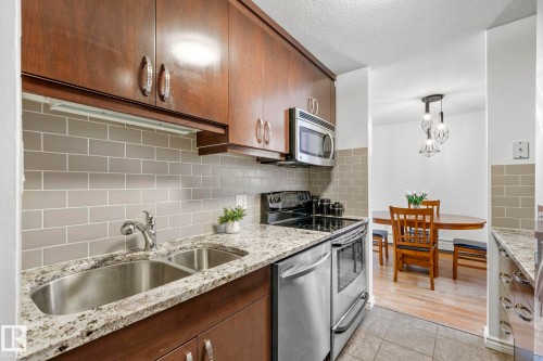 #105 11011 86 Av Nw, Edmonton, AB - Indoor Photo Showing Kitchen With Double Sink With Upgraded Kitchen