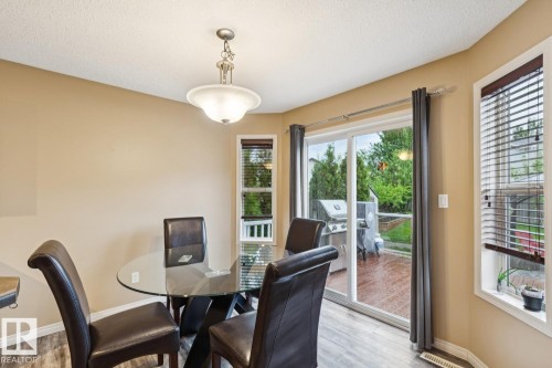 Dining area featuring wood-finish flooring and a pendant light fixture - 16765 119 Street Nw, Edmonton, AB - Indoor Photo Showing Dining Room