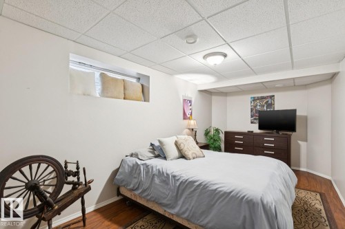 Recessed window opening with a drop ceiling, wood-finish flooring, and light wall tones - 16765 119 Street Nw, Edmonton, AB - Indoor Photo Showing Bedroom