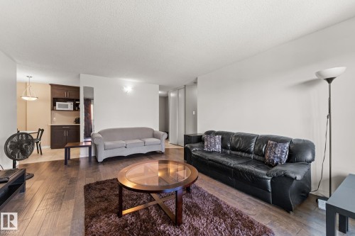 Open-concept living area featuring wood-finish flooring - #503 10175 114 St Nw, Edmonton, AB - Indoor Photo Showing Living Room