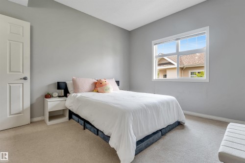 Neutral wall paint in a contemporary tone - #102 3040 Spence Wd Sw, Edmonton, AB - Indoor Photo Showing Bedroom