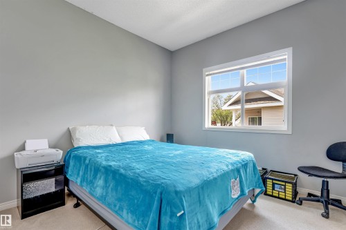 Room with light gray walls and carpeted flooring - #102 3040 Spence Wd Sw, Edmonton, AB - Indoor Photo Showing Bedroom