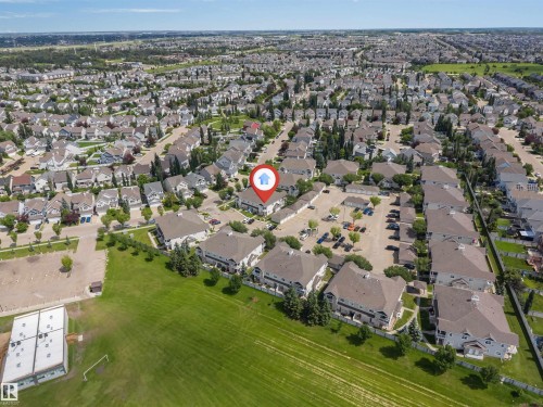 Residential community featuring multiple detached and attached properties with varied rooflines - #102 3040 Spence Wd Sw, Edmonton, AB - Outdoor With View