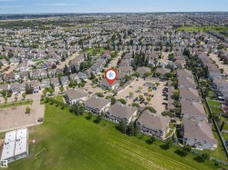 Residential community featuring multiple detached and attached properties with varied rooflines - 