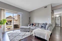 Living area featuring dark wood-finish flooring and light gray walls - 