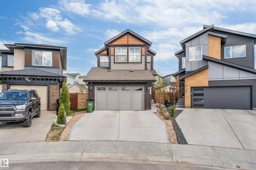 Contemporary two-story residence featuring a neutral siding facade, dark trim accents, and a two-car garage - 425 41 Street, Edmonton, AB - Outdoor With Facade