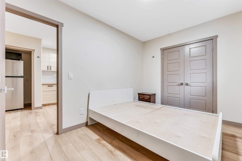 Light wood-finish flooring throughout, complemented by neutral wall tones - 425 41 Street, Edmonton, AB - Indoor