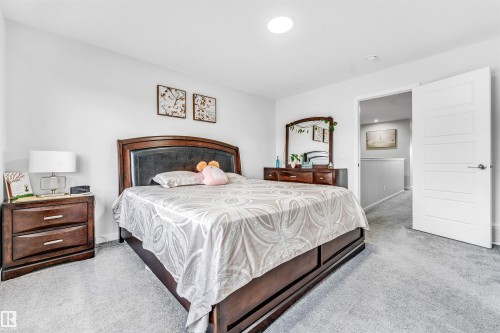 Carpeted room featuring a white paneled door, recessed ceiling lighting, and light-toned walls - 425 41 Street, Edmonton, AB - Indoor Photo Showing Bedroom