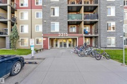Multi-story apartment building featuring a stone and siding exterior - 