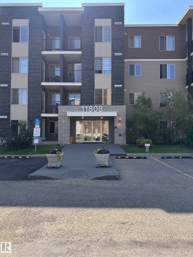 Multi-story building featuring stone veneer and horizontal siding - #419 11808 22 Av Sw, Edmonton, AB - Outdoor With Balcony With Facade