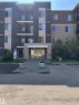 Multi-story building featuring stone veneer and horizontal siding - #419 11808 22 Av Sw, Edmonton, AB  - Outdoor With Balcony With Facade 