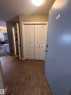 Entryway featuring wood-finish flooring, a flush-mount ceiling light, and a double-door closet with panel detailing - #419 11808 22 Av Sw, Edmonton, AB  - Indoor Photo Showing Other Room 