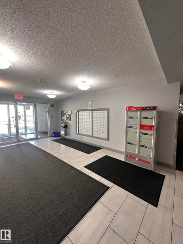 Building entry with tile flooring and a mail center - #419 11808 22 Av Sw, Edmonton, AB - Indoor Photo Showing Other Room
