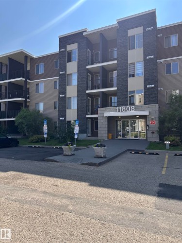 Multi-story condominium building featuring a stone facade and multiple balconies - #419 11808 22 Av Sw, Edmonton, AB - Outdoor With Balcony With Facade