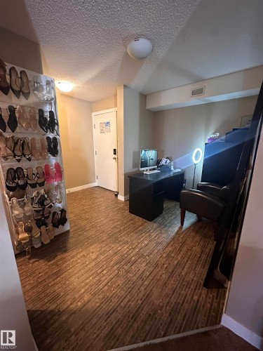 Versatile interior space featuring wood-finish flooring, neutral wall tones, and recessed lighting - #419 11808 22 Av Sw, Edmonton, AB - Indoor Photo Showing Other Room