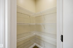 Spacious closet featuring white wire shelving system - 