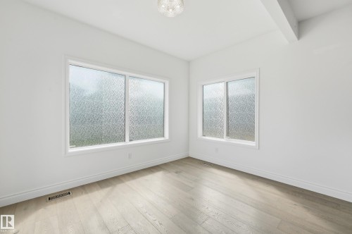 Room featuring light wood-finish flooring, white baseboards, and white walls - 1 Southfork Close, Leduc, AB - Indoor Photo Showing Other Room