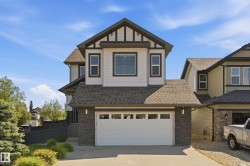 Two-story property featuring a stone and siding facade - 